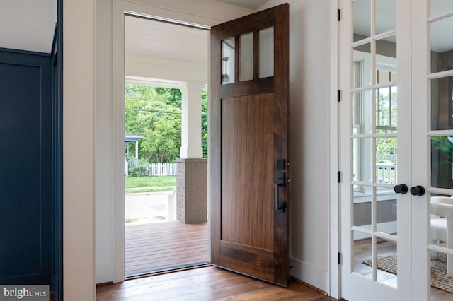 doorway to outside featuring wood finished floors and french doors