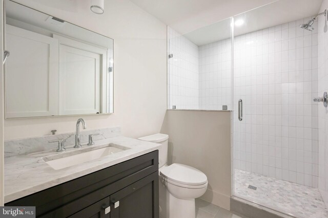 bathroom featuring a shower stall, toilet, tile patterned floors, and vanity