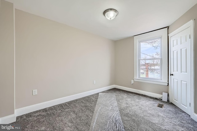 unfurnished bedroom with baseboards, carpet flooring, and visible vents