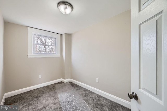 empty room featuring baseboards and carpet floors