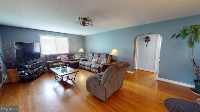 6103 Manor Rd, Clinton, MD 20735 - living area with arched walkways, wood finished floors, and baseboards