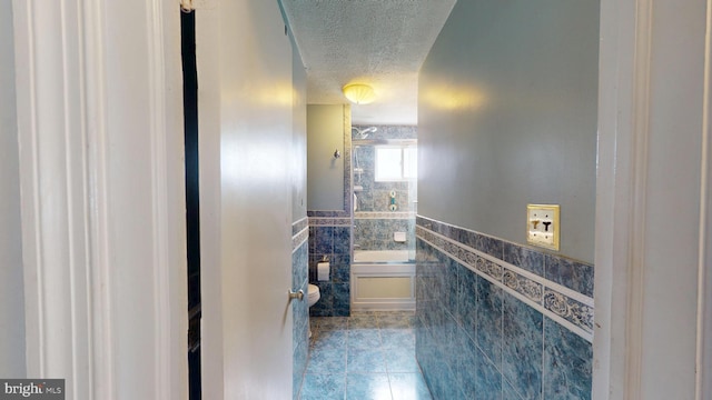 6103 Manor Rd, Clinton, MD 20735 - full bath with tile walls, a textured ceiling, tile patterned flooring, a wainscoted wall, and a bathtub