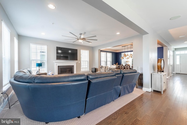 living area with recessed lighting, a ceiling fan, plenty of natural light, and hardwood / wood-style flooring