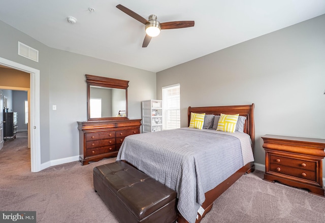 bedroom featuring a ceiling fan, baseboards, carpet, and visible vents