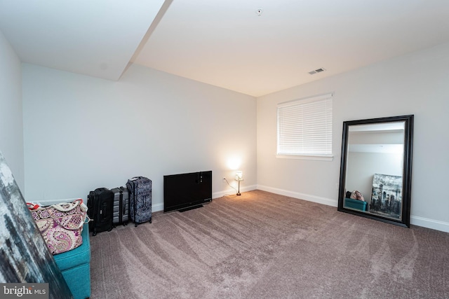 unfurnished room featuring carpet flooring, visible vents, and baseboards