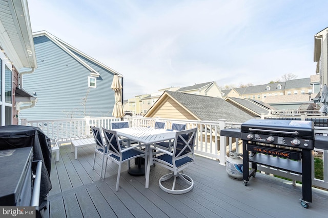 deck featuring area for grilling and outdoor dining area
