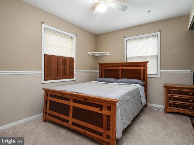 carpeted bedroom featuring baseboards and ceiling fan