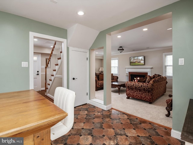 interior space featuring recessed lighting, stairs, a fireplace, and a healthy amount of sunlight