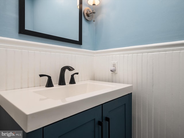 bathroom with a wainscoted wall and vanity