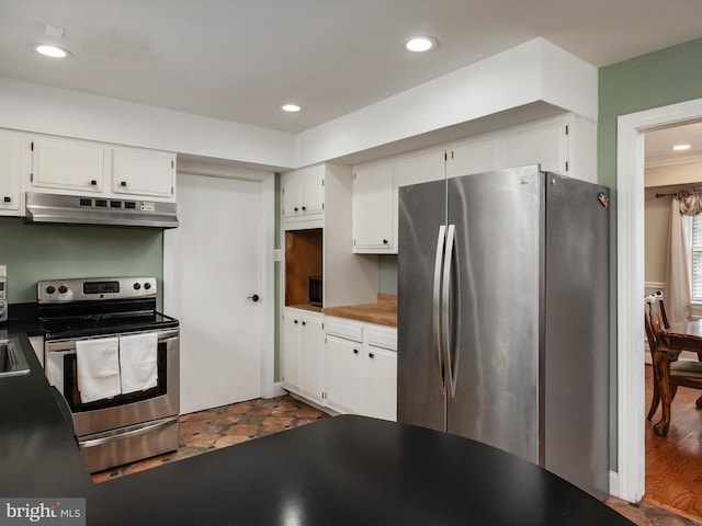 kitchen featuring under cabinet range hood, white cabinetry, appliances with stainless steel finishes, and recessed lighting