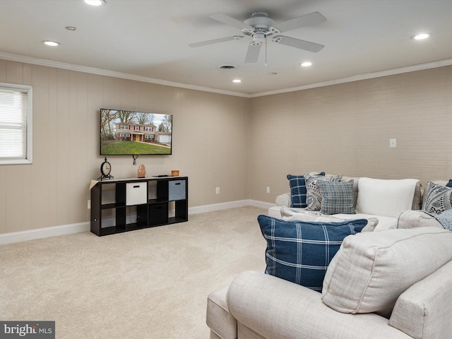 carpeted living room featuring visible vents, baseboards, ornamental molding, and ceiling fan