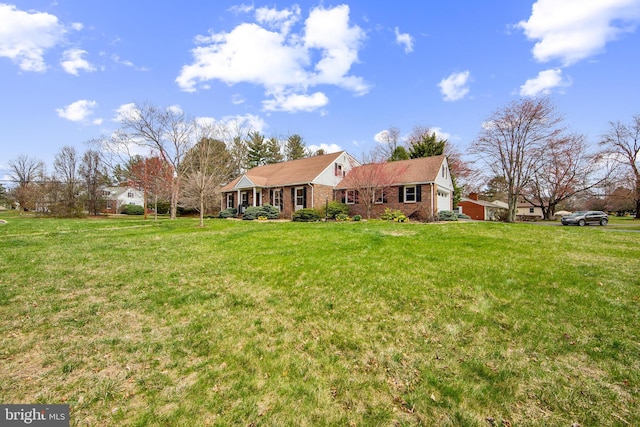 view of front of house with a front yard and brick siding