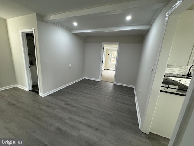 unfurnished bedroom featuring recessed lighting, baseboards, beamed ceiling, and dark wood finished floors
