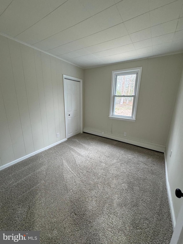 unfurnished bedroom with carpet flooring and baseboards