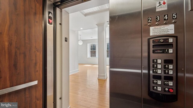 237 N Bread St Unit 4, Philadelphia, PA 19106 - detailed view of wood finished floors, ornate columns, baseboards, and elevator