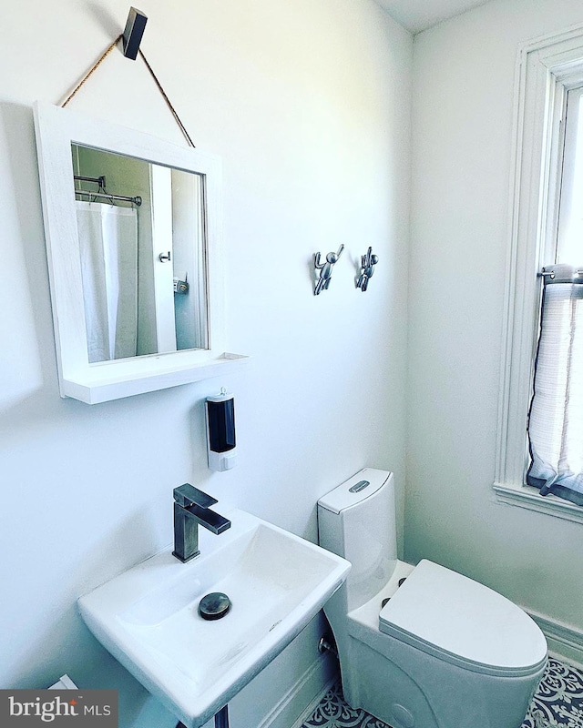 bathroom featuring toilet and a sink