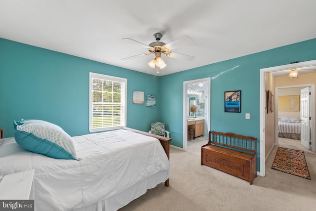 bedroom featuring carpet floors, a ceiling fan, baseboards, and ensuite bathroom