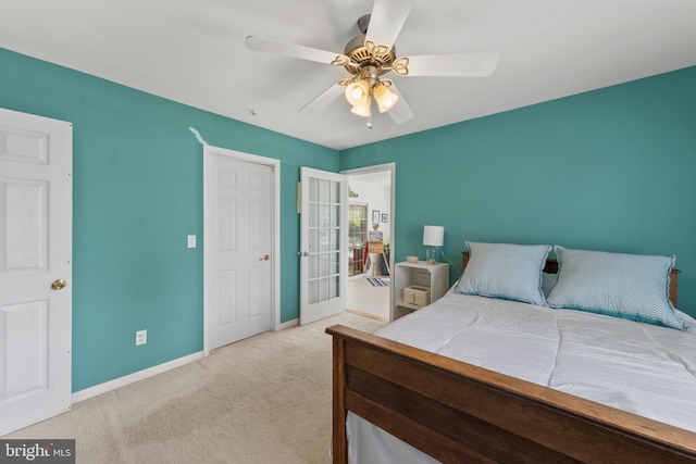 carpeted bedroom featuring a ceiling fan and baseboards