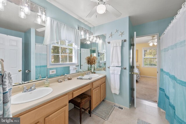 bathroom with double vanity, visible vents, ceiling fan, and a sink