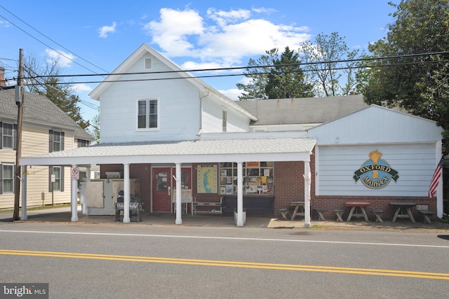 view of front facade featuring brick siding and a shingled roof