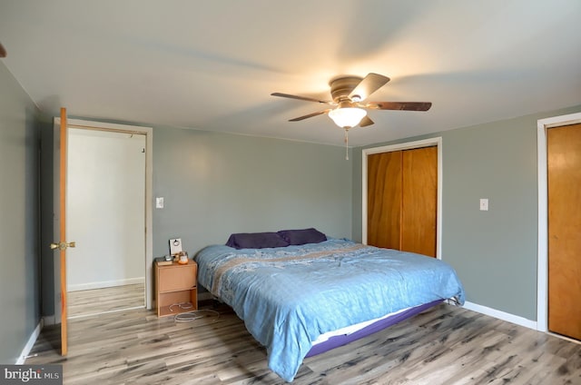 bedroom featuring baseboards, ceiling fan, and wood finished floors