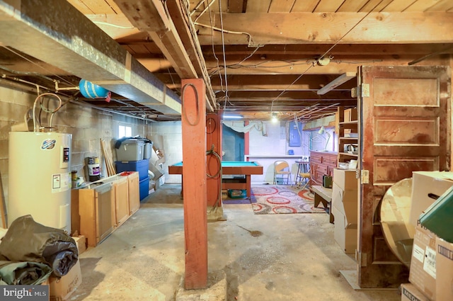basement with electric panel and electric water heater