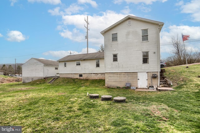 rear view of house featuring a lawn