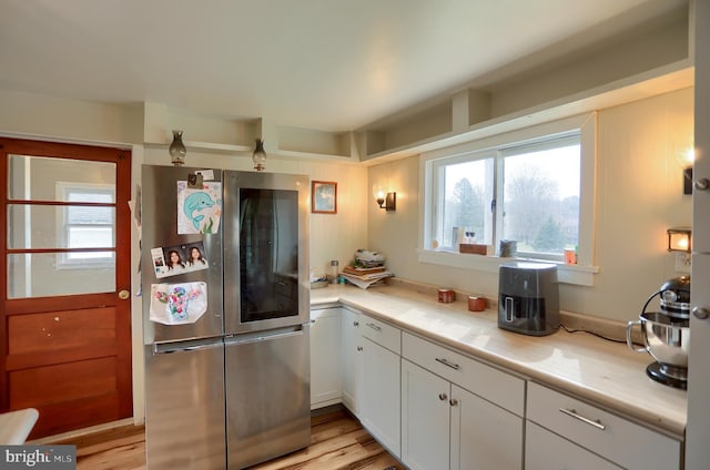 kitchen with white cabinetry, light countertops, smart refrigerator, and light wood-style flooring