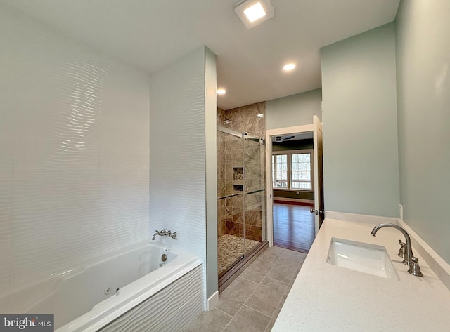 bathroom with a shower stall, a jetted tub, a sink, and recessed lighting