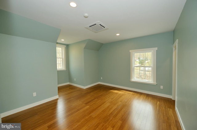 bonus room featuring visible vents, baseboards, recessed lighting, and wood finished floors