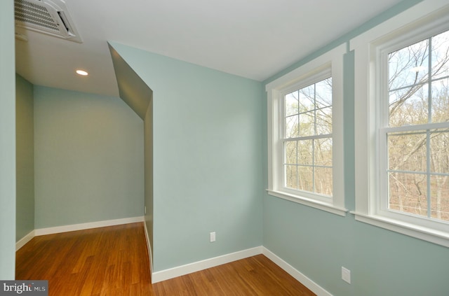 interior space featuring wood finished floors, baseboards, visible vents, and recessed lighting