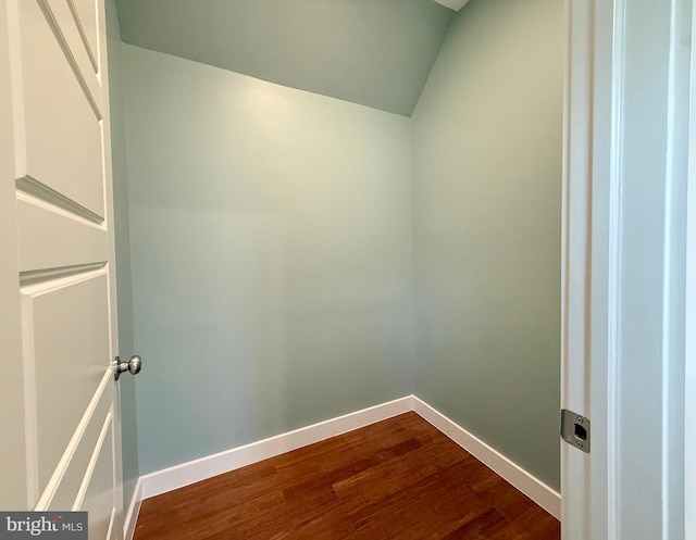 interior space with dark wood finished floors and vaulted ceiling