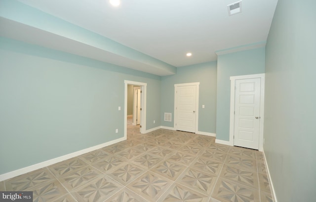 unfurnished room with baseboards, visible vents, and recessed lighting