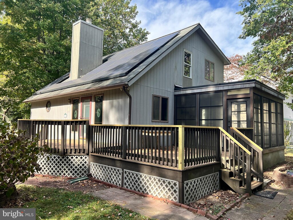 113 Comanche Cir, Millsboro, DE 19966 - rear view of house featuring a chimney and a deck