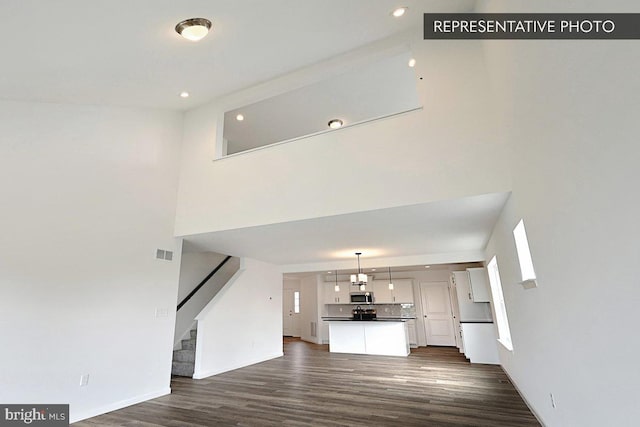 346 Acer Ave Lot 728B, State College, PA 16803 - unfurnished living room featuring stairway, recessed lighting, dark wood-style flooring, a towering ceiling, and visible vents