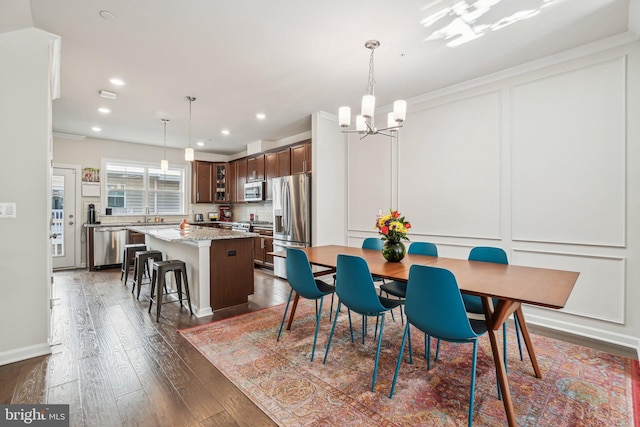 dining area with baseboards, recessed lighting, a notable chandelier, and dark wood-style floors