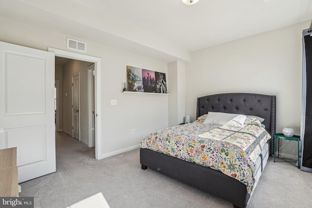 bedroom with visible vents, light colored carpet, and baseboards