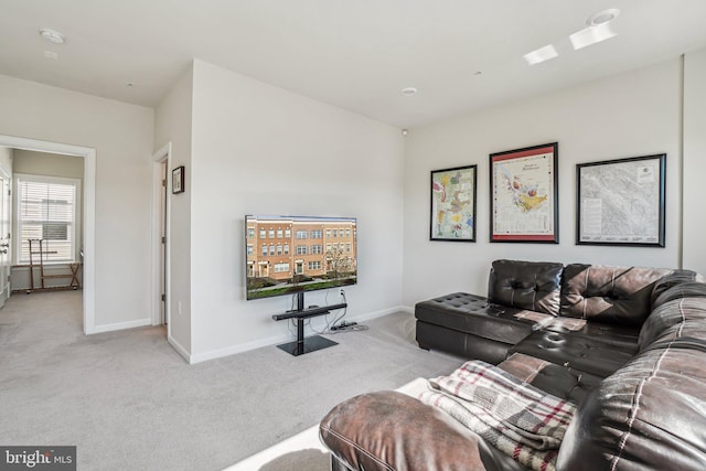 living area with baseboards and carpet