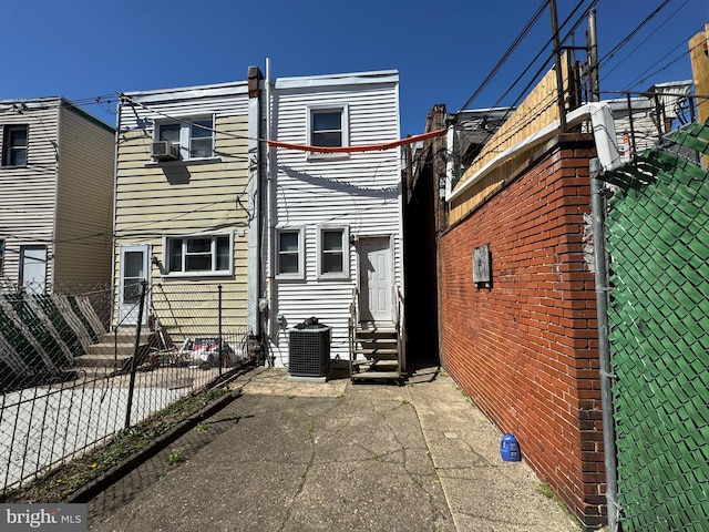 5259 N 5th St, Philadelphia, PA 19120 - back of property with entry steps, fence, and central AC