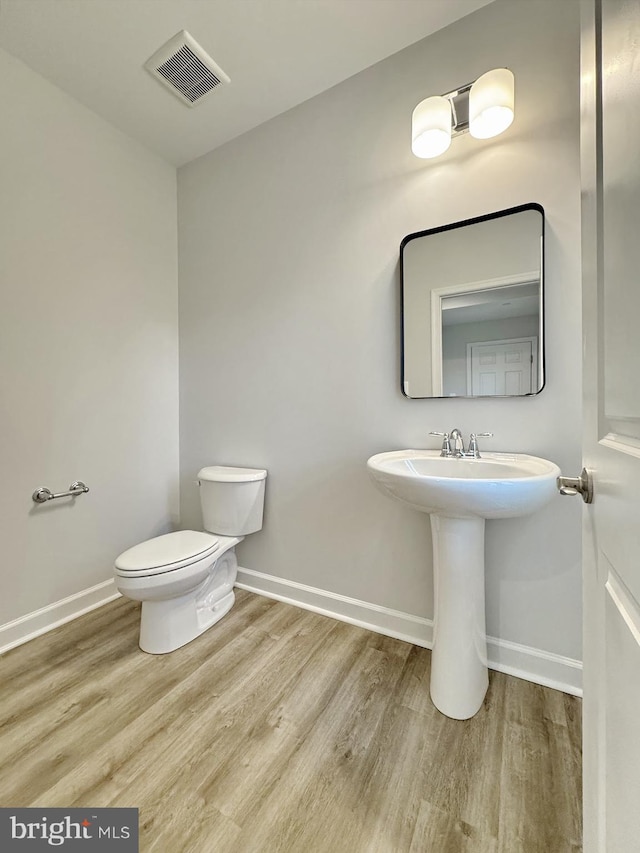 9871 La Plata Pkwy, La Plata, MD 20646 - half bath featuring baseboards, visible vents, and wood finished floors