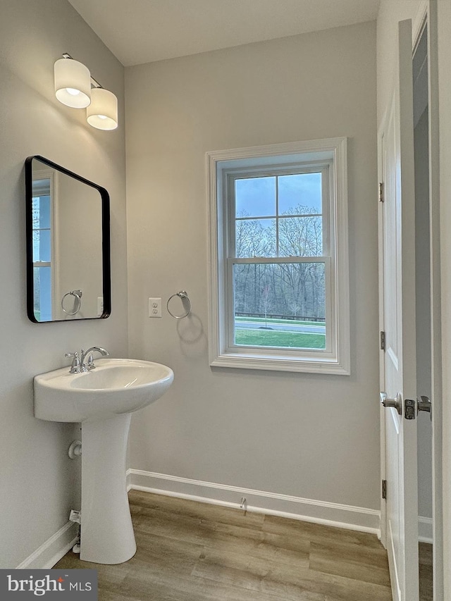 9871 La Plata Pkwy, La Plata, MD 20646 - bathroom featuring baseboards, wood finished floors, and a sink
