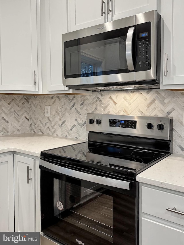 9871 La Plata Pkwy, La Plata, MD 20646 - kitchen with white cabinetry, light stone countertops, tasteful backsplash, and appliances with stainless steel finishes