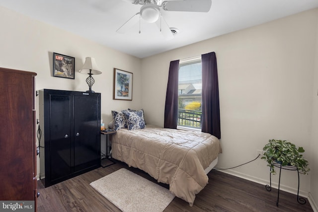 bedroom with ceiling fan, baseboards, and wood finished floors