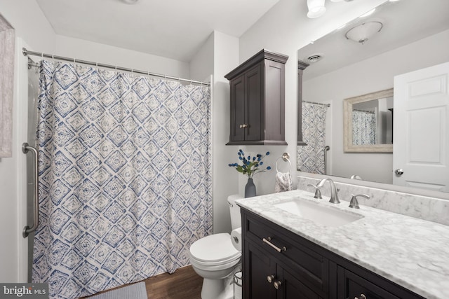 bathroom with vanity, toilet, and wood finished floors