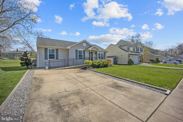 view of front of house featuring concrete driveway, a residential view, and a front lawn