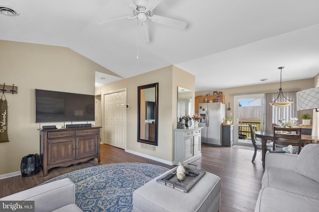 living room featuring visible vents, baseboards, ceiling fan, dark wood finished floors, and vaulted ceiling
