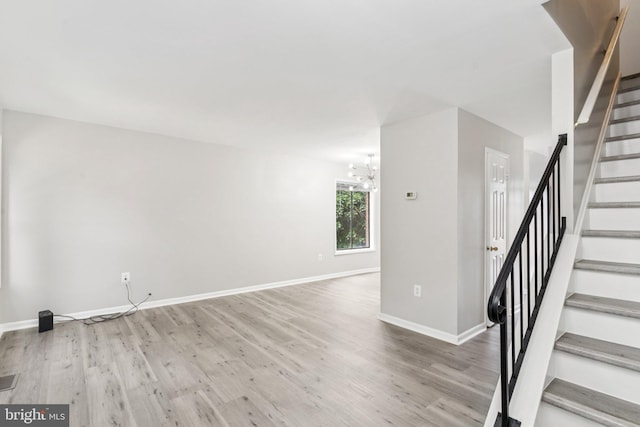 4647 6th St SE, Washington, DC 20032 - spare room with stairs, a chandelier, and wood finished floors