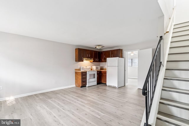 4647 6th St SE, Washington, DC 20032 - kitchen with white appliances, under cabinet range hood, light wood-type flooring, light countertops, and ceiling fan