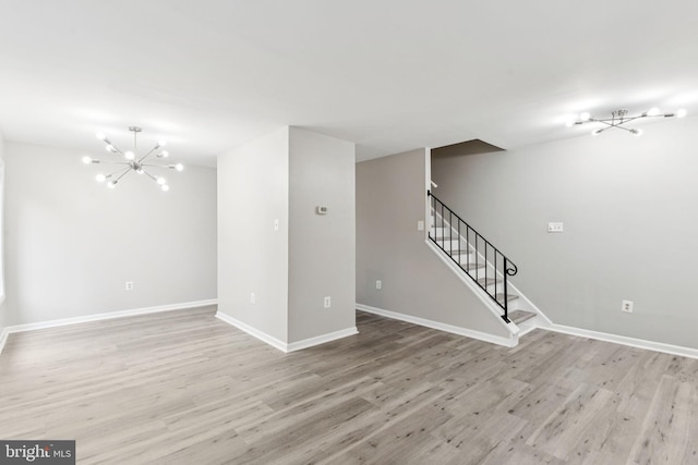 4647 6th St SE, Washington, DC 20032 - unfurnished living room with a chandelier, light wood-style floors, and stairs