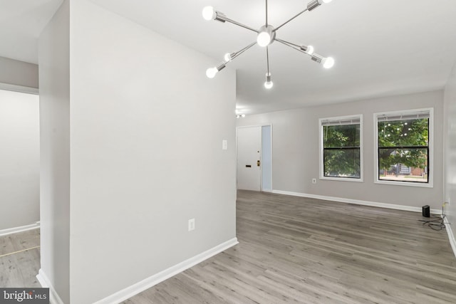 4647 6th St SE, Washington, DC 20032 - empty room with wood finished floors and a chandelier